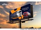 The image is a digital billboard with a blue and orange color scheme. The billboard is located on a highway with a beautiful...