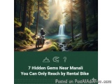 The image shows a person riding a motorcycle on a dirt road in a forest. The person is wearing a helmet and a jacket, and the...