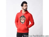 The image shows a young man wearing a red hoodie with a graphic design on the front. The hoodie has a drawstring hood and a k...