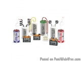 The image shows a group of six different types of capacitors. There are six capacitors in total, each with a different color...