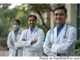 The image shows three doctors standing in a line with their arms crossed. They are all wearing white lab coats and stethoscop...