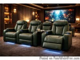 The image shows a home theater room with a large screen on the wall. The room has dark wood paneling on the walls and a carpe...