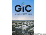 The image is a photograph of the Gurgaon International City, a city in India. The photograph is taken from a high angle, look...