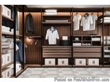 The image shows a modern and luxurious walk-in closet with wooden shelves and drawers. The closet has a large wooden wardrobe...