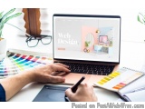 The image shows a person's hands working on a laptop with the website "Web Design" displayed on the screen. The laptop is pla...