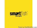The image is a logo for a company called "smartfish designs". The logo is written in black text on a bright yellow background...