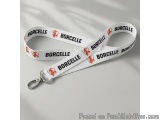The image shows a white lanyard with the word "Borcelle" written in red capital letters on it. The word is written in a cursi...