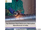 The image shows a person working on a stainless steel reservoir fabrication machine. The person is wearing a green jacket and...
