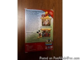 The image is a photograph of the back cover of a Disney Learning Preschool book. The cover is red and orange in color and has...