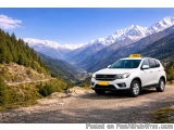 The image shows a white SUV with a yellow taxi sign on the roof, parked on a dirt road in a mountainous area. The car is faci...