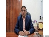 The image is a still from a video posted on PostAllAds4Free.com. It shows a man sitting at a desk in an office. He is wearing...