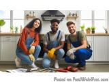 The image shows three young people, two men and a woman, kneeling on the floor in a kitchen. They are all wearing blue overal...
