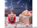 The image is a romantic scene with a pink gift box on the right side and a glass jar filled with red rose petals on the left...