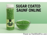 The image shows a jar of sugar coated saunf online. The jar is made of glass and has a white lid. The label on the jar is gre...
