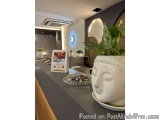The image shows a modern and minimalist interior design of a room with a gray countertop. On the countertop, there is a white...