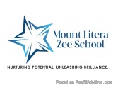 The image is a logo for Mount Litera Zee School. It is a blue star-shaped logo with the school's name written in white text b...