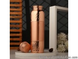 The image shows a copper-colored water bottle with a lid on a white marble base. The bottle has a cylindrical shape with a wi...