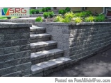 The image shows a set of stairs made of gray stone blocks. The stairs are located on the right side of the image, leading up...