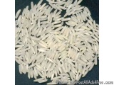 The image is a close-up of a pile of white rice grains. The grains are arranged in a circular pattern, with some overlapping...