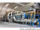 The image shows a large industrial plant with a high ceiling and metal beams. The plant appears to be a waste tyre pyrolysis...
