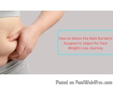 The image shows a person's lower body, specifically their stomach, with their hand gently touching their stomach. The person...