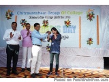 The image shows a group of five people standing on a stage with a banner that reads "Chitravansham Group of College (Knowledg...