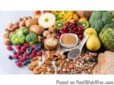 The image is a flat lay of various fruits and vegetables arranged on a white plate. There are a variety of fruits such as app...