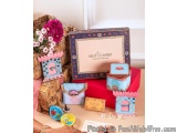 The image shows a collection of items on a table. There is a large blue box with the words "Knot Company" written on it in go...