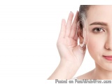 The image shows a close-up of a young woman's face. She is holding a clear plastic earring in her right hand, which is restin...