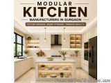 The image is of a modern kitchen in Gurgaon, India. The kitchen has a sleek and contemporary design with white cabinets and b...