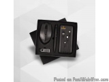 The image shows a black box with a black mouse and a pen inside. The box is rectangular in shape and has a handle on the top...