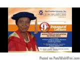 The image is a photograph of a woman wearing a graduation cap and gown. She is standing in front of a blue background with th...