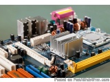 The image shows a close-up of a computer motherboard with various electronic components. The motherboard is blue in color and...