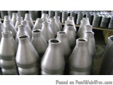 The image shows a large number of cylindrical metal objects, which appear to be made of steel or aluminum. The objects are ar...