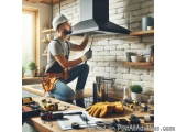 In this image, we can see a man wearing a white hard hat and overalls, working in a kitchen. He is sitting on a wooden workbe...