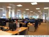 The image shows an office space with multiple cubicles and desks. The cubicles are arranged in rows and columns, and the desk...
