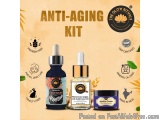 The image is an advertisement for an anti-aging kit. It features three products - a face serum, a Moroccan Argan oil, and a j...