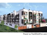 The image is a 3D rendering of a modern apartment complex. The complex is made up of multiple buildings with white walls and...