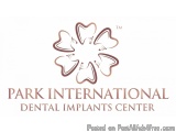 The image is a logo for Park International Dental Implants Center. It is a simple design with a white background and a brown...
