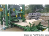 The image shows a large industrial machine, which appears to be a concrete block making machine. It is green in color and has...