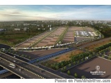 The image is an aerial view of a large industrial area. The area is surrounded by greenery and there are several roads and hi...
