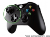 The image is of a black Xbox wireless controller. The controller has a round button on the top left corner with the Xbox logo...