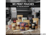 The image shows a collection of all-in-one pouches mockups on a wooden table. There are nine pouchees in total, arranged in a...