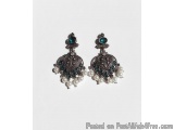 The image shows a pair of earrings. The earrings are made of silver and have a teardrop shape. The top of the earrings have a...