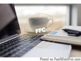 The image shows a laptop computer on a desk with a cup of coffee and a notebook next to it. The laptop is open and the screen...