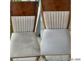 The image shows a side view of a wooden chair with a beige upholstered seat. The chair has a wooden frame with a curved backr...