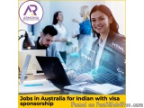 The image shows a group of people working in an office. There are three people in the image, two men and one woman, all worki...