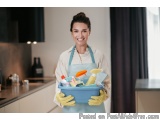 In this image, we can see a young woman wearing a blue apron and yellow rubber gloves, holding a blue plastic container fille...