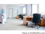 The image shows an empty office space with a modern design. The room has a large window on the right side, allowing natural l...