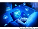 The image shows a person sitting on a couch with a laptop in front of them. The laptop screen displays the word "ERP" in blue...